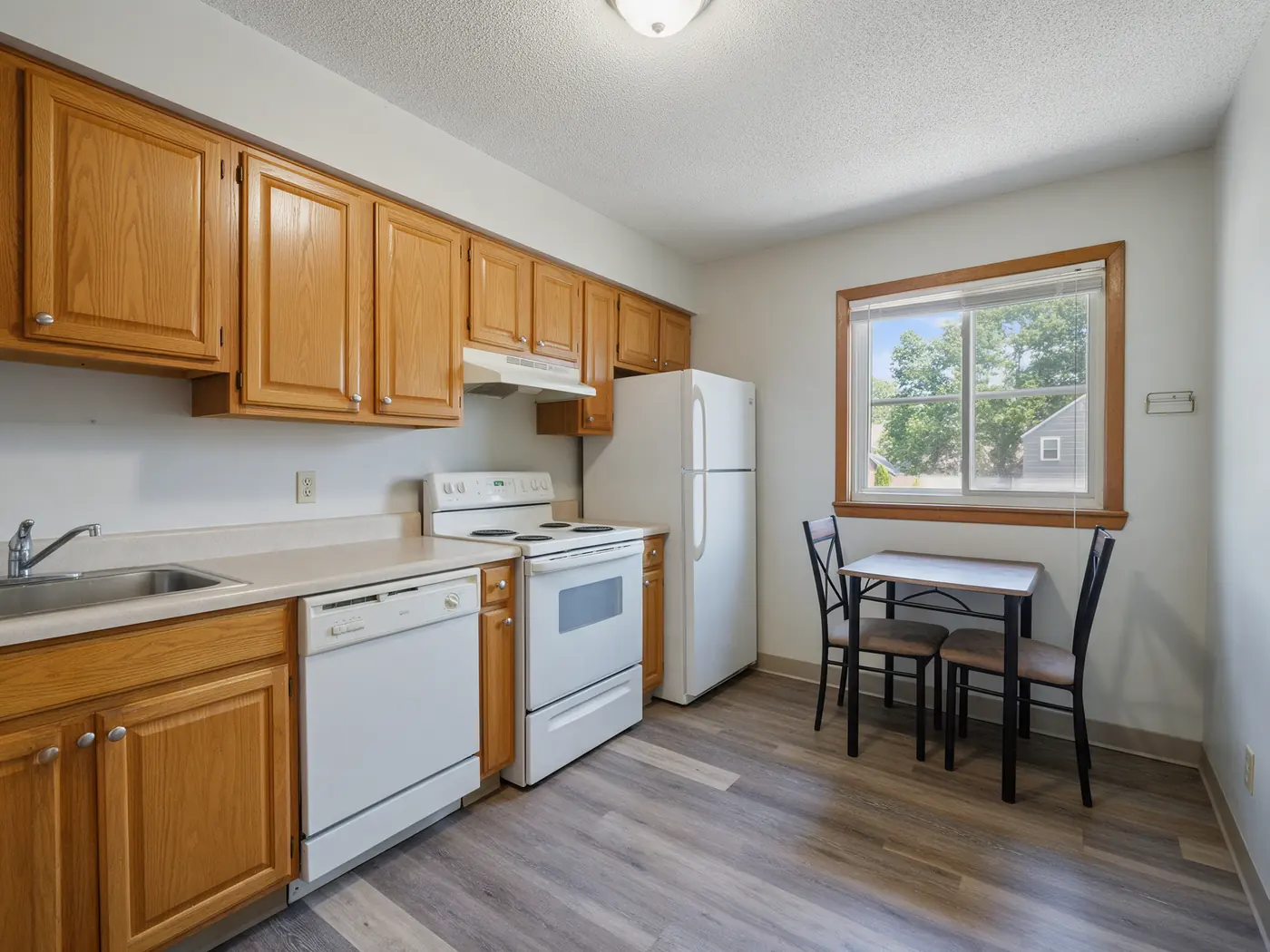 Representative photo of an apartment kitchen with a small table by the window
